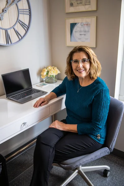 Rachele Epp, LMHC sitting at her desk